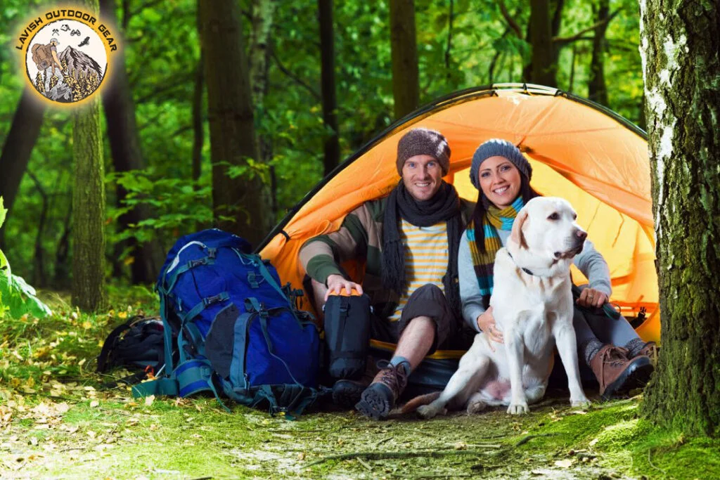 a couple with their pet dog on a camping trip