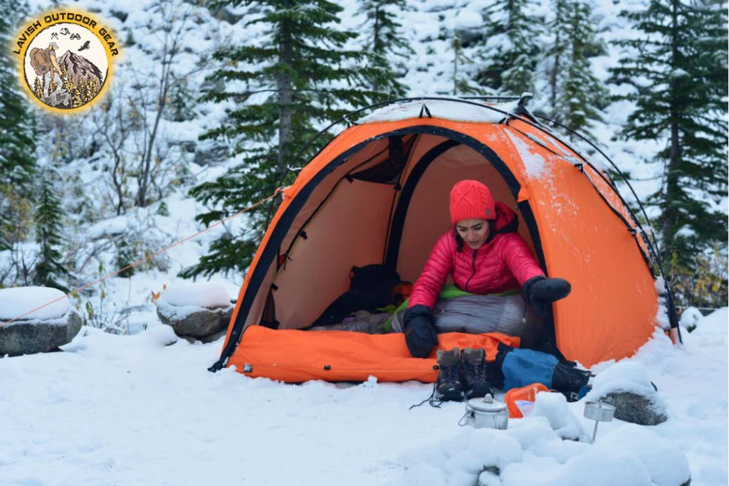 young girl camping in the snow