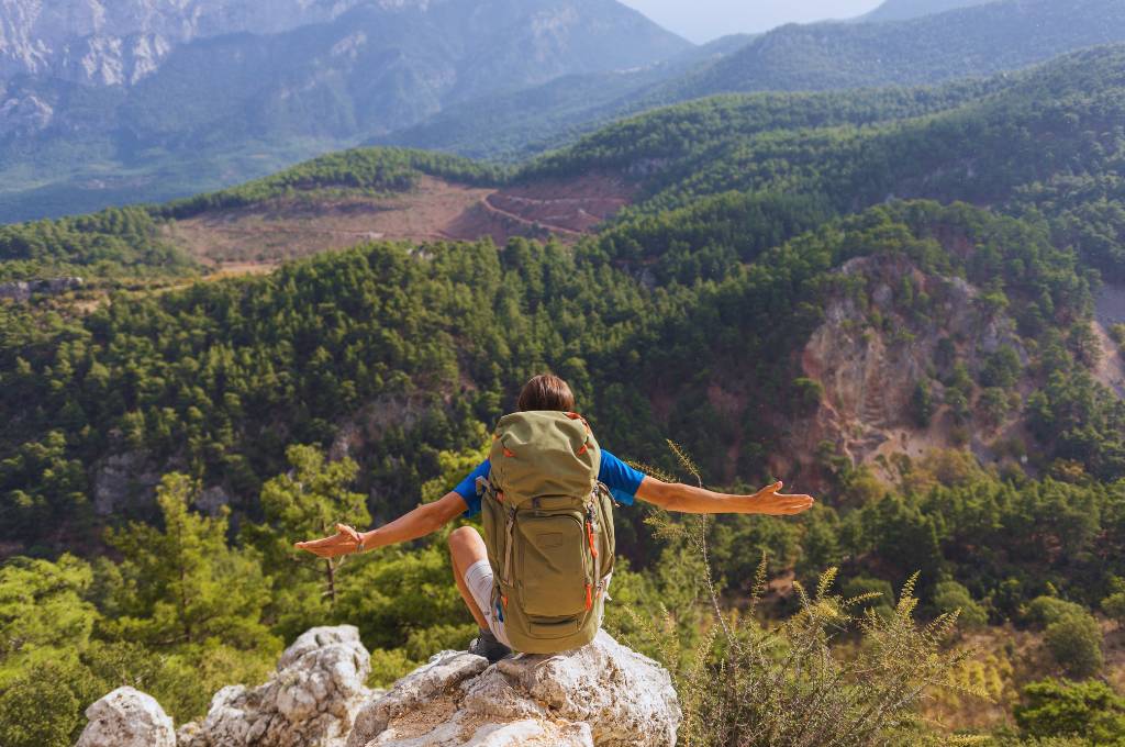 a backpacker in the top of mountain enjoying the view
