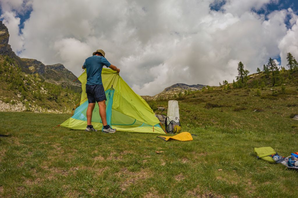 man setting up a camp in the mountains