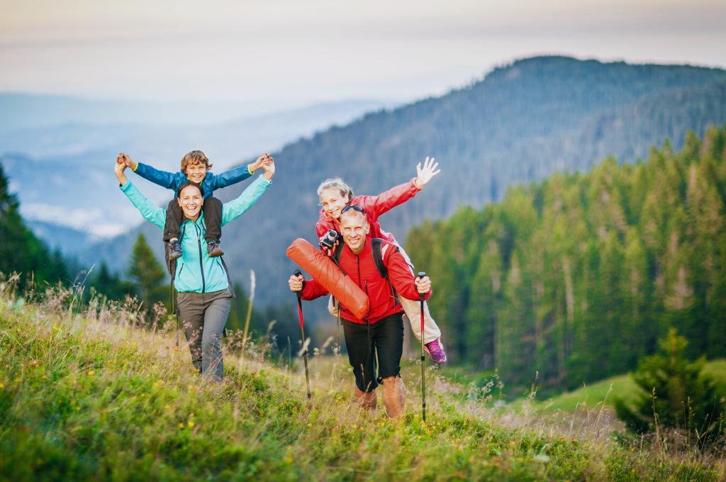 a happy family backpacking on the mountains