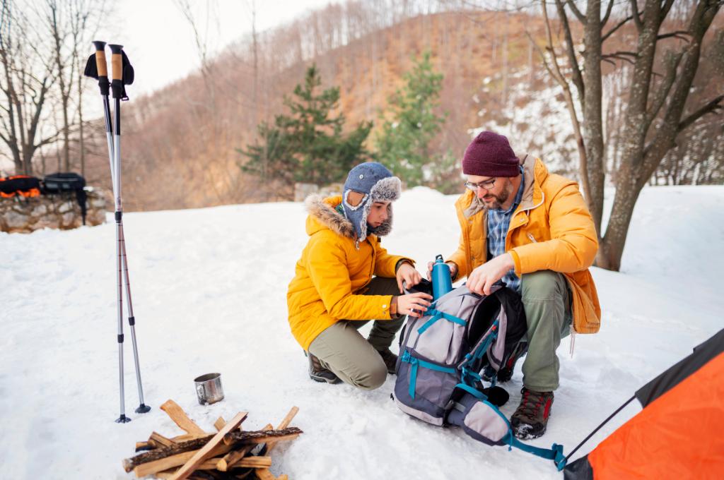 a son and dad on winter camping
