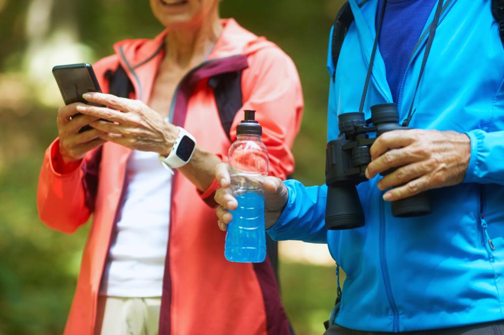 Senior Backpackers with their mobile phone on the trail